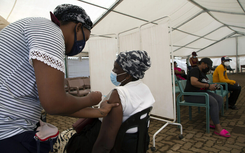 A woman receives a dose of a COVID-19 vaccine at a center, in Soweto, South Africa, on Monday, November 29, 2021. (AP Photo/Denis Farrell)