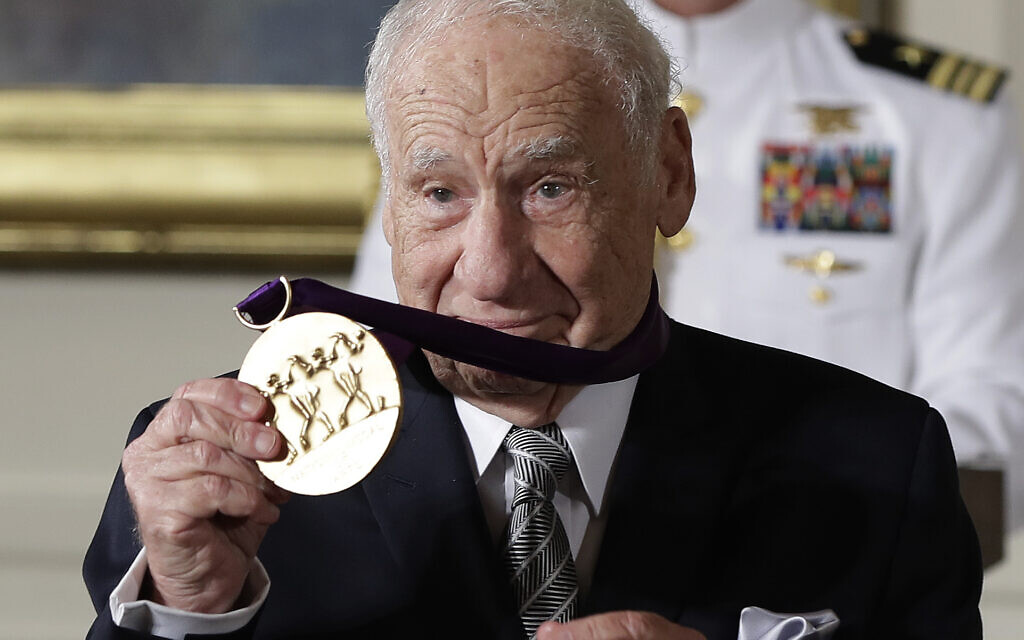 Actor, comedian and writer, Mel Brooks, holds up his 2015 National Medal of Arts awarded to him by President Barack Obama during a ceremony at the White House in Washington, DC, on September 22, 2016. (AP Photo/Carolyn Kaster, File)