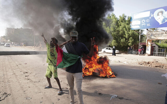 Protesters call for a civilian government during demonstrations near the presidential palace in Khartoum, Sudan, Tuesday, Nov. 30, 2021. (AP Photo/Marwan Ali)