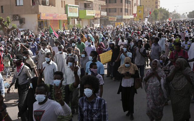 Tens of thousands of Sudanese calling for a civilian government march near the presidential palace in Khartoum, Sudan, on November 30, 2021. (AP Photo/Marwan Ali)