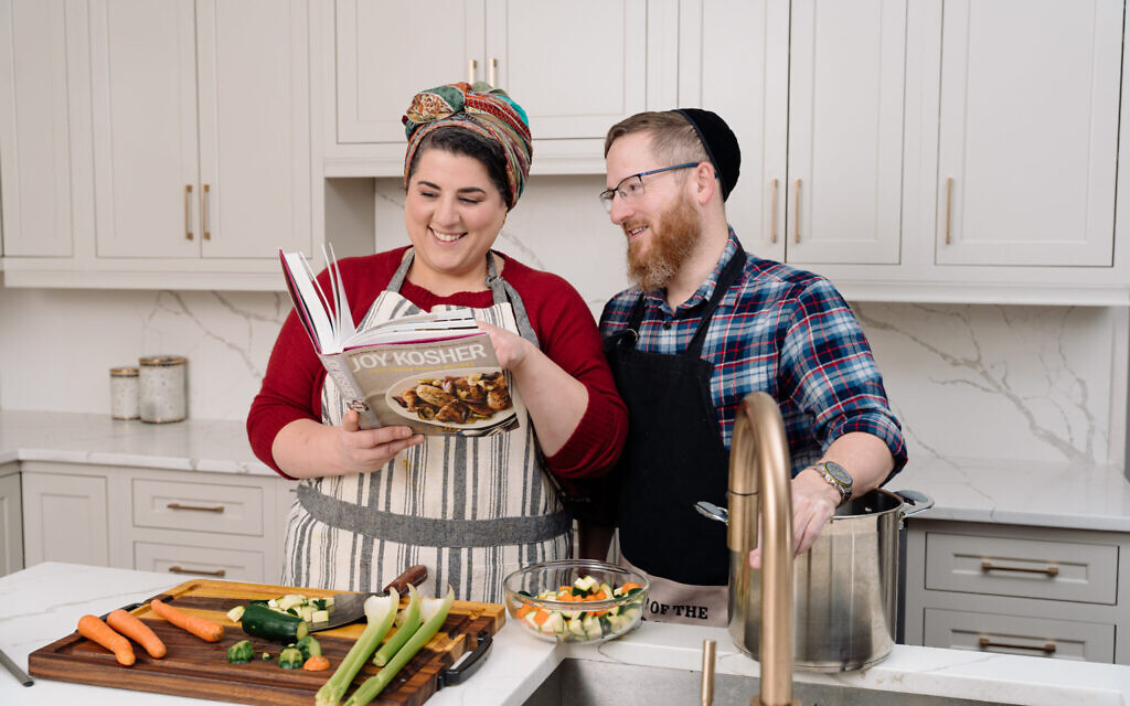 Chana Bernstein Arnold and her husband Shmuel 'cooking' for a Jewish Life Photo Bank photo shoot. (Courtesy/ Jewish Life Photo Bank)