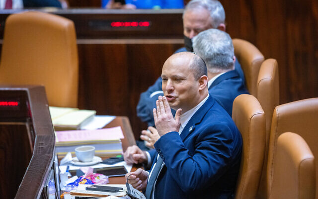 Prime Minister Naftali Bennett blows a kiss at an opposition MK during a plenum session and a vote on the state budget in the Knesset, on November 3, 2021. (Olivier Fitoussi/Flash90)