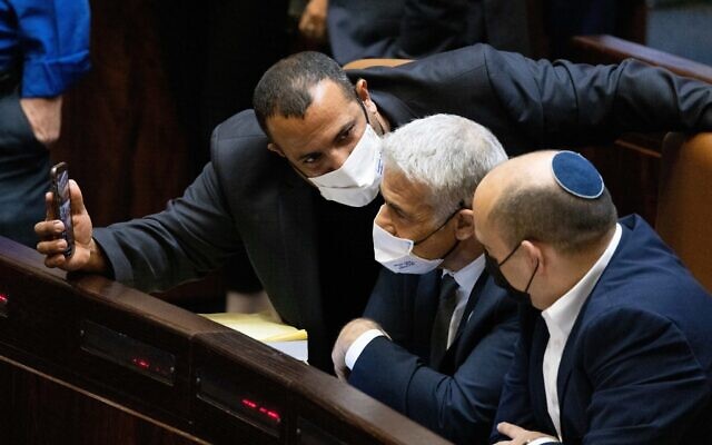 Prime Minister Naftali Bennett (right) seen with Minister of Foreign Affairs Yair Lapid (center) and MK Abir Kara during a plenum session and a vote on the state budget at the Knesset plenum in Jerusalem on November 4, 2021. (Yonatan Sindel/ Flash90)