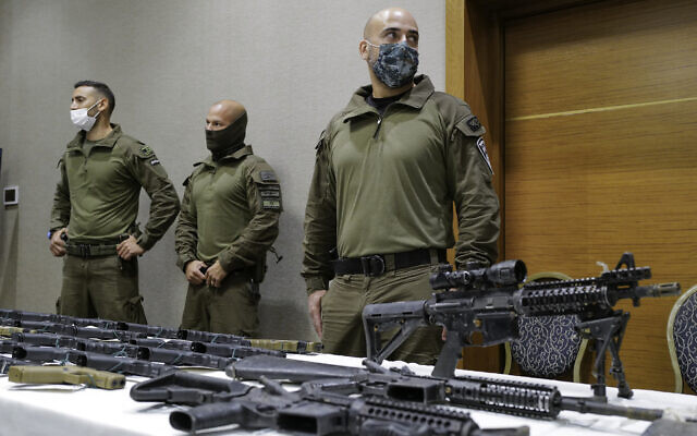 Illegal weapons seized by police are displayed during a ceremony in the northern city of Nazareth, on November 9, 2021. (Michael Giladi/Flash90)