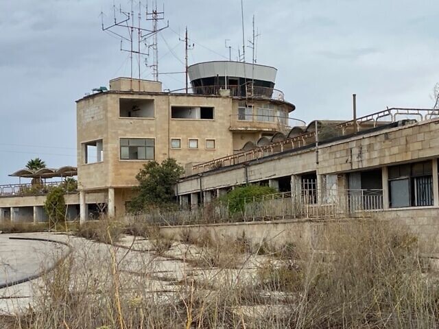 The road and entry point for passengers to the abandoned terminal building of Jerusalem Airport at Atarot, November 2021. (David Horovitz / Times of Israel)