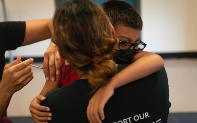Jeffery Vargas, 7, hugs his mother, Marisela Warner, while receiving the Pfizer COVID-19 vaccine at a pediatric vaccine clinic for children ages 5 to 11 set up at Willard Intermediate School in Santa Ana, Calif., Tuesday, Nov. 9, 2021. (AP Photo/Jae C. Hong)