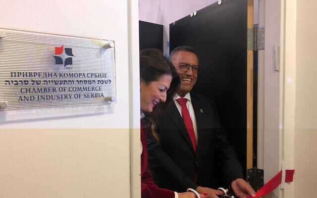 Serbia's Trade and Tourism Minister Tatjana Matic (L) and Jerusalem Mayor Moshe Lion (R) cut the ribbon at the Serbian Chamber of Commerce innovation office in Jerusalem, November 14, 2021 (Lazar Berman/Times of Israel)
