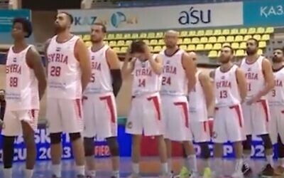 Screen capture from video of the Syrian national basketball team listening as the Iranian national anthem is erroneously played in their honor before a game in the first leg of Asian qualifiers for World Cup 2023 in Kazakhstan, November 27, 2023. (Twitter)