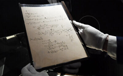 Pages of one of the preparatory manuscript to the theory of general relativity of Albert Einstein, during their presentation a day before being auctioned at Christie's auction house in Paris, on November 22, 2021. (Alain Jocard/AFP)