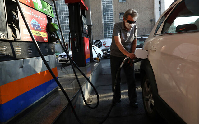 A man fills his car at a gas station amid a cyber attack on the nation's fuel system, in Tehran, Iran, October 27, 2021. (AP Photo/Vahid Salemi)