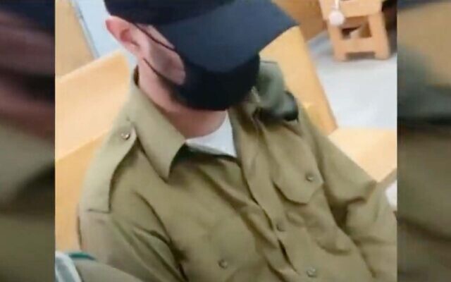 Dan Sharoni, an IDF officer accused of sexual offenses, appears in court in news footage broadcast on November 24, 2021. (Screenshot)
