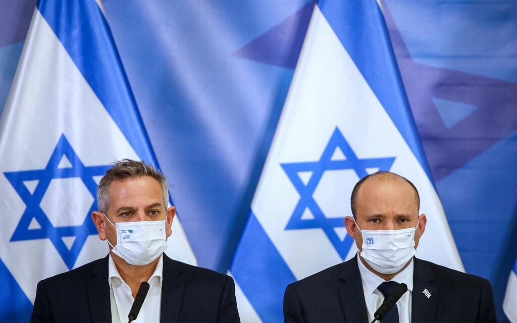Prime Minister Naftali Bennett (right) and Health Minister Nitzan Horowitz (left) hold a press conference at Kirya military base in Tel Aviv, on November 26, 2021. (Moti Milrod/Pool via Flash90)