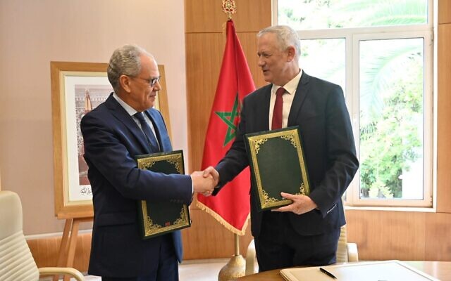 Defense Minister Benny Gantz, right, shakes hands with his Moroccan counterpart Abdellatif Loudiyi, after signing a memorandum of understanding between the two countries at the Moroccan Defense Ministry in Rabat on November 24, 2021. (Defense Ministry)