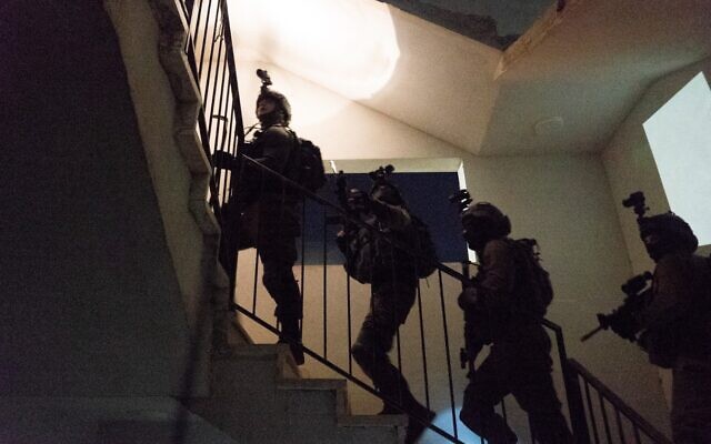 An undated photograph showing Israeli forces raiding a home as part of an effort to break up a major Hamas cell planning terror attacks on Israeli targets in the West Bank and Jerusalem. (Israel Defense Forces)
