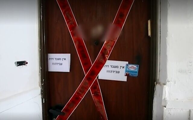 The door to a Beersheba apartment where an 18-year-old woman was found dead, November 13, 2021. (Screen grab/Ynet)