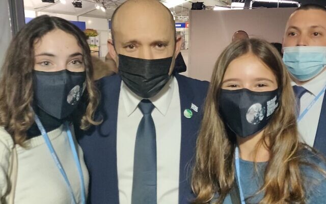 Alma Pomagrin, 15 (R) and Lia Lev (16) of the Israel branch of Fridays4Future meet with Prime Minister Naftali Bennett at the UN climate conference in Glasgow, Scotland, on November 1, 2021. (Sue Surkes/Times of Israel)
