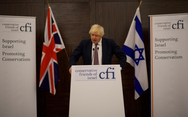 UK Prime Minister Boris Johnson speaks to Conservative Friends of Israel in London, Britain, alongside Israel's Foreign Minister Yair Lapid, November 29, 2021. (Stuart Mitchell)