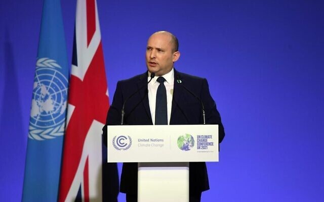 Prime Minister Naftali Bennett delivers a speech on stage during a meeting at the COP26 UN Climate Change Conference in Glasgow, Scotland, on November 1, 2021. (Haim Zach/GPO)