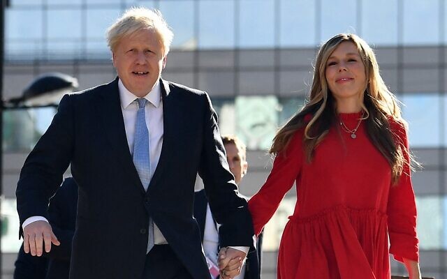 (FILES) In this file photo taken on October 6, 2021 Britain's Prime Minister Boris Johnson (L) and his wife Carrie (R) arrive at the Manchester Central convention centre ahead of his keynote speech on the final day of the annual Conservative Party Conference in Manchester, northwest England. - Johnson became a father again, after his wife, Carrie, gave birth to a girl, Downing Street said on December 9, 2021. (Photo by Ben STANSALL / AFP)