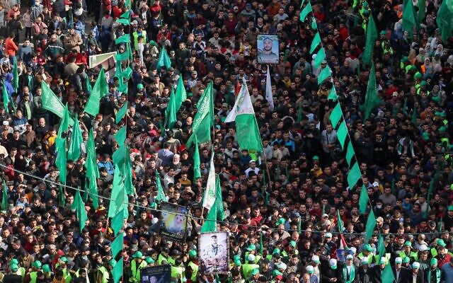 People participate in a rally in the Jabaliya refugee camp in the Gaza Strip, marking the 34th anniversary of the founding of  Hamas which rules the coastal enclave, December 10, 2021. (Mohammed ABED / AFP)