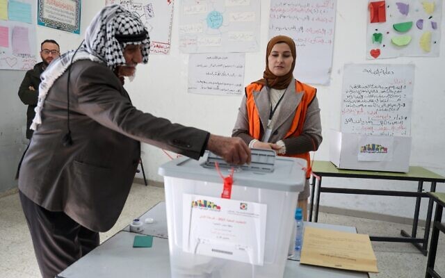 A Palestinian man votes at a polling station in Beit Dajan, east of Nablus in the northern West Bank, on December 11, 2021. (Jaafar Ashtiyeh/AFP)