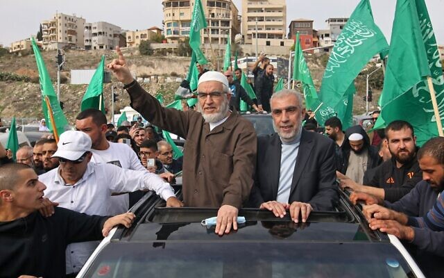 Sheikh Raed Salah (center left), leader of the radical northern branch of the Islamic Movement in Israel, celebrates with supporters following his release from a jail in the Arab city of Umm al-Fahm in northern Israel, on December 13, 2021. (Ahmad Gharabli/AFP)