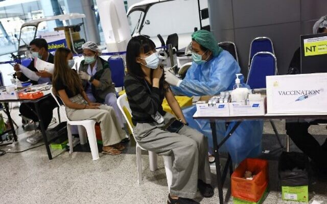 A woman receives a Covid-19 coronavirus vaccine at the Bang Sue Central Vaccination Centre in Bangkok on December 15, 2021, as Thailand speeds up its roll out of booster shots to guard against the Omicron variant. (Photo by Jack TAYLOR / AFP)
