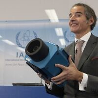 Rafael Mariano Grossi, director general of the IAEA, presents a surveillance camera at the International Atomic Energy Agency's headquarters in Vienna, Austria, on December 17, 2021. (Alex Halada/AFP)