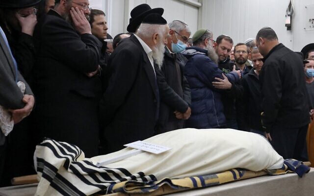 Mourners attend the funeral of Yehuda Dimentman, in Jerusalem, on December 17, 2021. Dimentman was shot dead in a December 16 terror attack. (GIL COHEN-MAGEN / AFP)