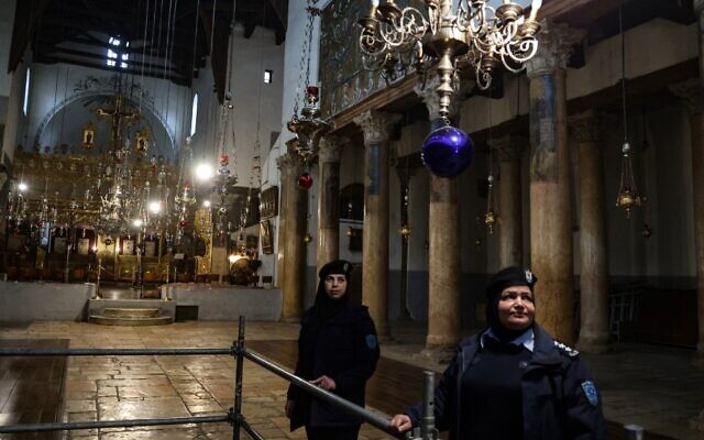 Palestinian security forces stand guard inside the Church of the Nativity, ahead of Christmas celebrations in the biblical city of Bethlehem on December 24, 2021. (Jaafar Ashtiyeh / AFP)
