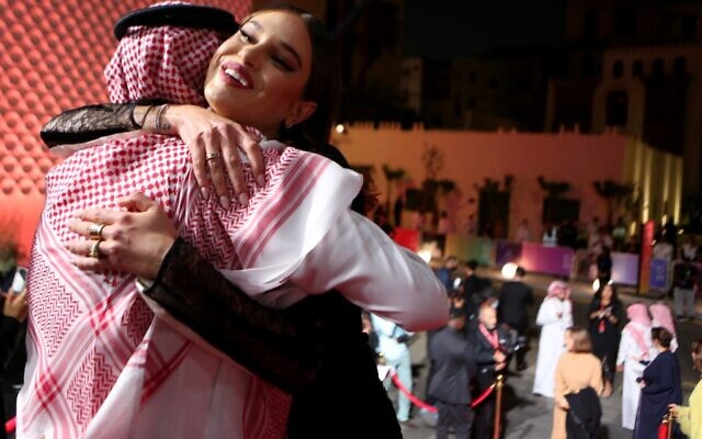 US model Meredith Mickelson hugs Red Sea Film Festival chairman Mohammed al Turki upon her arrival at the opening of the first edition of the festival in the Saudi city of Jeddah, on December 6, 2021. (PATRICK BAZ / Red Sea Film Festival)