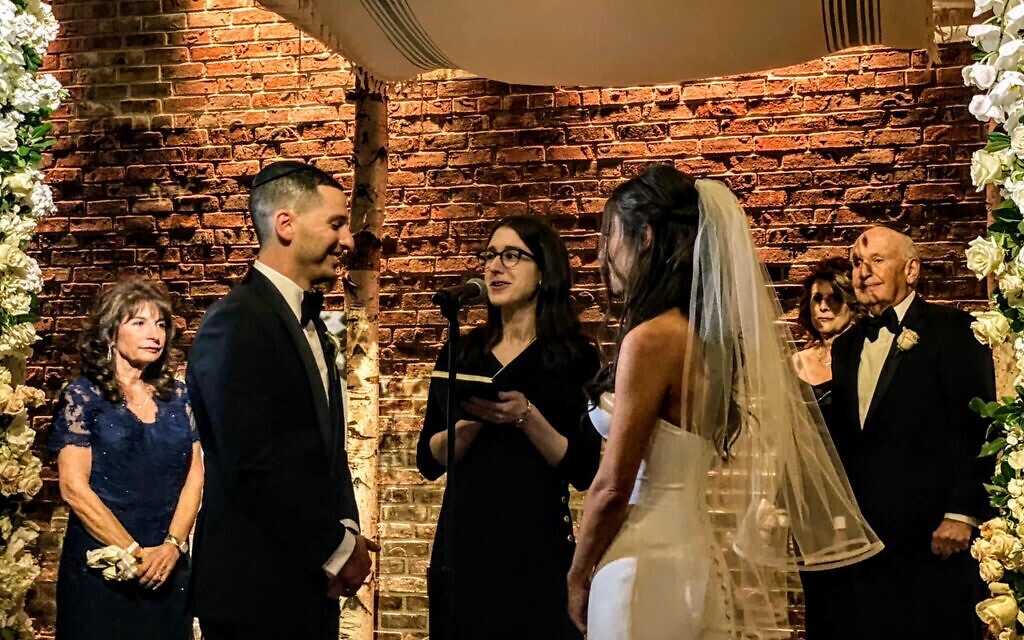 Rabbi Yael Buechler, center, officiated at the wedding of Pamela Rosen and Jared Daniels on November 13, 2021, a weekend in which her father and brother, both rabbis, also officiated at Jewish weddings. (Courtesy Pamela Rosen and Jared Daniels/ via JTA)