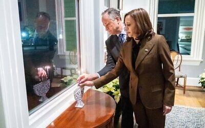 US Vice President Kamala Harris, left, and Second Spouse Douglas Emhoff and light a menorah on the first night of Hanukkah at their home in Washington DC, Nov. 28, 2021. (Twitter)