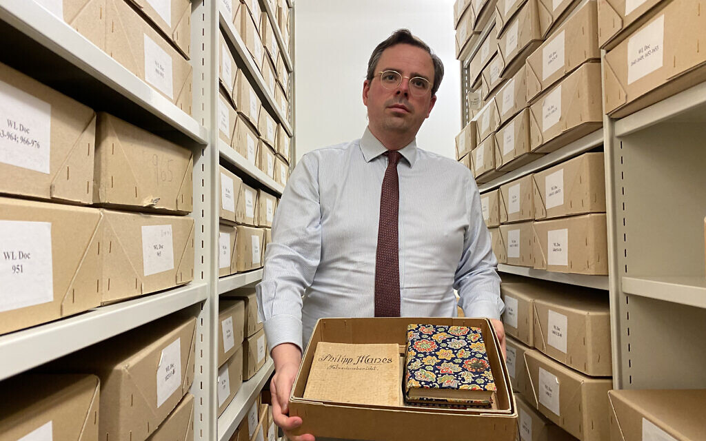 Toby Simpson shows a reporter documents in the Wiener Holocaust Library in central London. (Jacob Judah/ JTA)