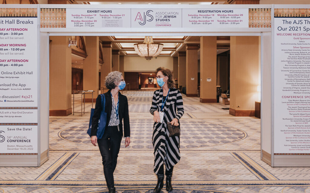 Scholars Beth Berkowitz (left) and Christine Hayes walk and talk during the 53rd Association of Jewish Studies Annual Conference, held at the Sheraton Grand Chicago, December 19, 2021. (Joe Underbakke/ via JTA)