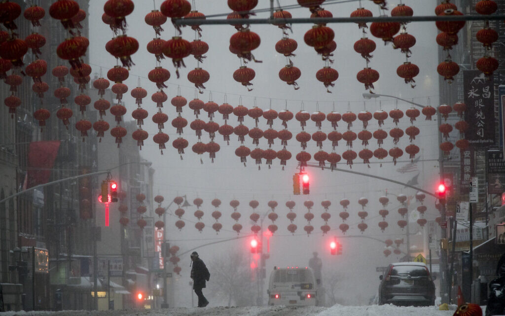 Illustrative: A pedestrian crosses East Broadway during a snowstorm, March 14, 2017, in the Chinatown neighborhood of New York. (AP Photo/Mary Altaffer)
