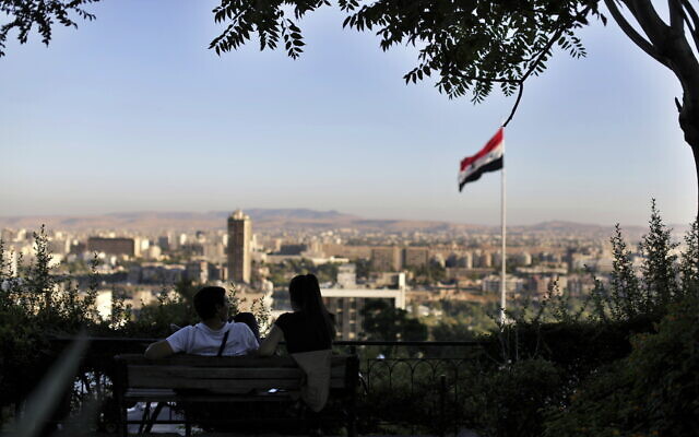 Illustrative: In this July 24, 2019 file photo, a young couple sits in a public garden overlooking the Syrian capital Damascus, Syria. (AP Photo/Hassan Ammar)