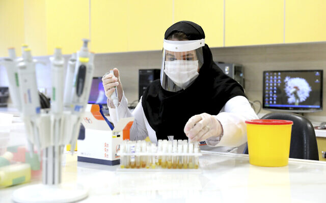 FILE -- A scientist works in a lab on coronavirus testing kits just outside Tehran, Iran, April 11, 2020 (AP Photo/Ebrahim Noroozi)