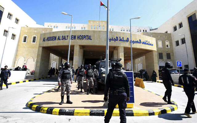 Soldiers stand guard outside Al-Hussein Al Salt Hospital in Salt, Jordan on March 13, 2021 (AP Photo/Raad Adayleh)