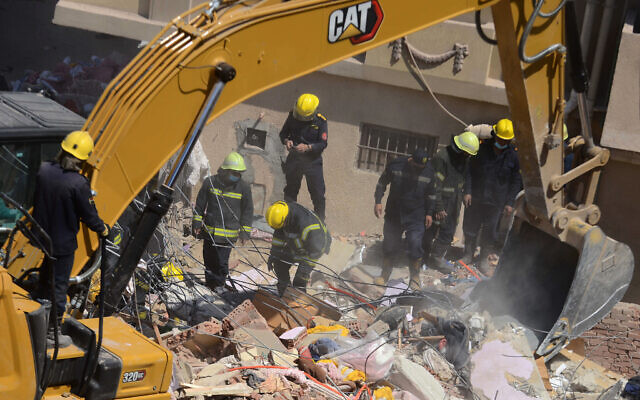 Illustrative -- Rescuers look for victims on the rubble of a collapsed apartment building in the el-Salam neighborhood, in Cairo, Egypt, March 27, 2021 (AP Photo/Tarek wajeh)