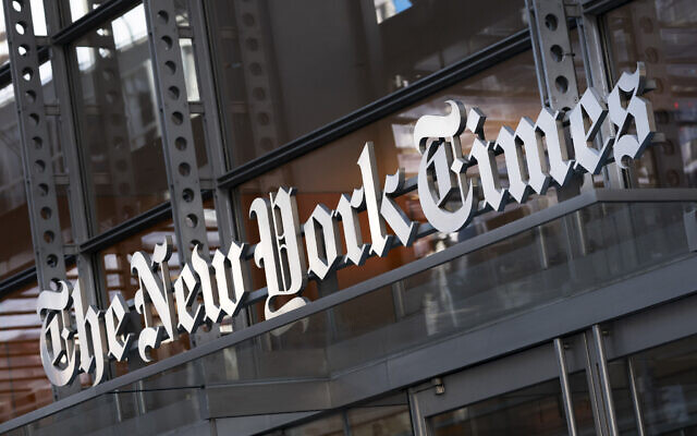 In this Thursday, May 6, 2021 file photo, a sign for The New York Times hangs above the entrance to its building, in New York.  (AP Photo/Mark Lennihan, File)