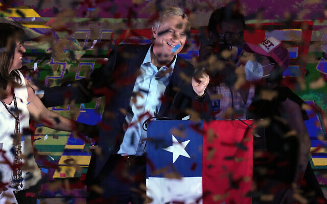 Republican Party presidential candidate Jose Antonio Kast and his wife Maria Pia Adriasola stand before supporters amid confetti at his campaign headquarters after polls closed and partial results were announced in Santiago, Chile, November 21, 2021. (AP/Esteban Felix)