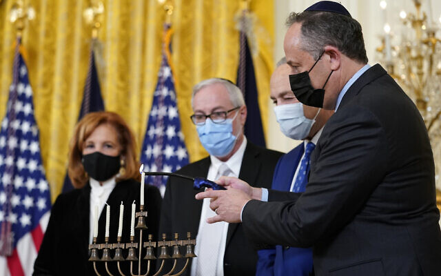 Second gentleman Doug Emhoff, right, lights the menorah in the East Room of the White House in Washington, during an event to celebrate Hanukkah, Wednesday, Dec. 1, 2021. (AP/Susan Walsh)