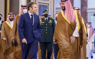 In this photo released by Saudi Royal Palace, Saudi Crown Prince Mohammed bin Salman greets French President Emmanuel Macron, left, upon his arrival in Jeddah, Saudi Arabia, Saturday, Dec. 4, 2021. (Bandar Aljaloud/Saudi Royal Palace via AP)