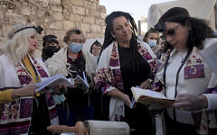 Members of Women of the Wall gather around a Torah scroll the group smuggled in for their Rosh Hodesh prayers marking the new month at the Western Wall, where women are forbidden from reading from the Torah, December 5, 2021. (AP Photo/Maya Alleruzzo)