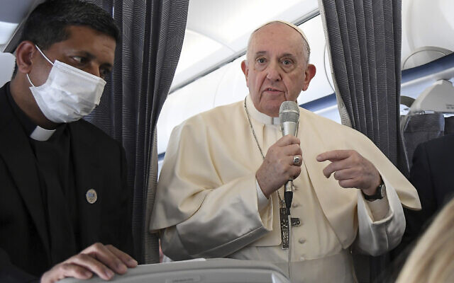 Pope Francis greets the journalists onboard the papal plane on the occasion of his five-day pastoral visit to Cyprus and Greece, Dec. 6, 2021 (Alessandro Di Meo/Pool photo via AP)
