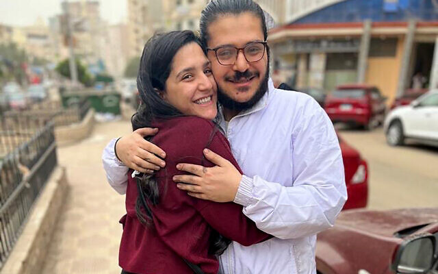 Patrick George Zaki hugging his sister after his release, outside the police station in Nile Delta city of Mansoura, Egypt, December 8, 2021. (EIPR via AP)