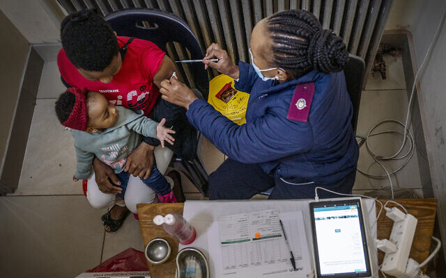 FILE - A woman is vaccinated against COVID-19 at the Hillbrow Clinic in Johannesburg, South Africa, Dec. 6, 2021 (AP Photo/ Shiraaz Mohamed, File)