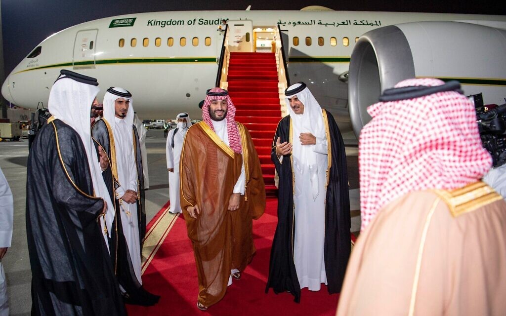 In this photo released by Saudi Royal Palace, Saudi Crown Prince Mohammed bin Salman, center left, is greeted by Qatar's Emir Sheikh Tamim bin Hamad Al Thani upon his arrival at Doha airport in Qatar late Dec. 8, 2021  (Bandar Aljaloud/Saudi Royal Palace via AP)