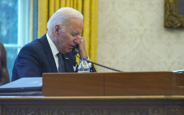 President Joe Biden talks on the phone  from the Oval Office of the White House in Washington, December 9, 2021. (AP Photo/Susan Walsh)